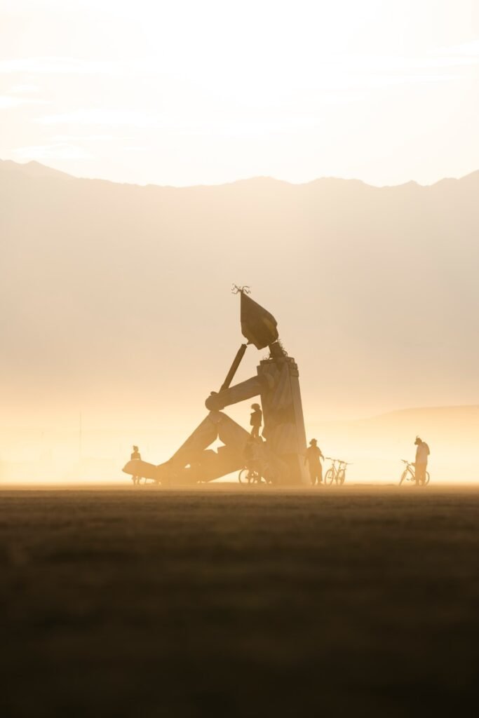 A couple of people sitting on top of a field